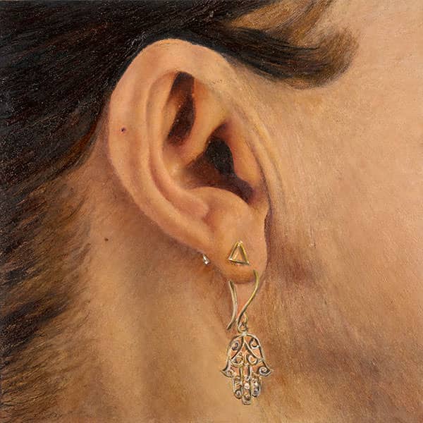 “The Lover” – Panel 4 of Frank Brennan’s photorealistic oil portrait, showing a woman’s ear adorned with a silver earring shaped like a Hamsa hand.